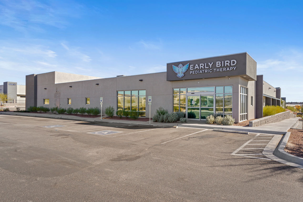 Bright and open physical therapy floor with modern equipment.