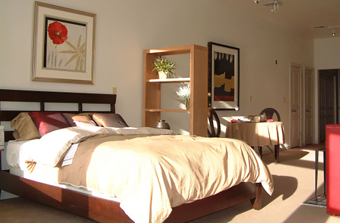 Interior loft apartment with high ceilings and large windows.